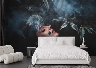 A young woman with her eyes closed, surrounded by foliage and smoke. Wall mural