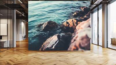 Close-up of calm water lapping against rocks. Wall mural