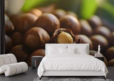 Close-up of macadamia nuts, one is cracked open revealing the white nut. Wall mural