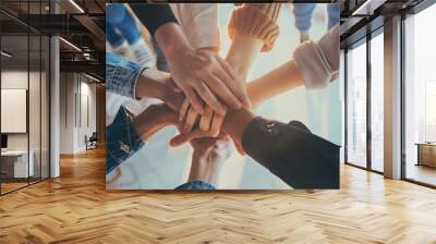 Collaboration and camaraderie among colleagues with hands on top of each other Wall mural