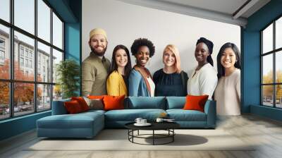 Diverse group of young adults smiling together against a neutral background, representing unity and multiculturalism in a professional setting. Wall mural