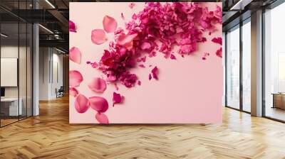 Pink rose petals scattered on a soft pink background. Wall mural