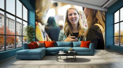 Professional women engaging in lively networking conversation at a business conference. Wall mural