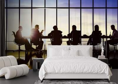 Silhouetted business professionals in a meeting in a modern office with large windows at sunset Wall mural