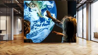 Three children stand in awe of a large globe displaying a detailed map of the Earth. Wall mural