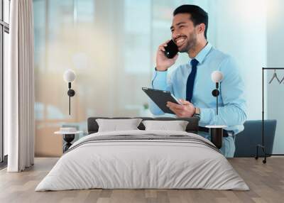 Business man talking on a phone while browsing on a digital tablet in an office. Dedicated sales executive and young expert communicating project plans and discussing deals with clients in a company Wall mural