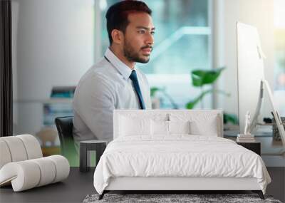 Busy male Accountant typing an email in a modern office. A financial advisor compiling a finance proposal for a successful company. A serious Auditor writing a business investment report Wall mural