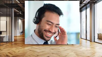 Call center agent consulting a buyer via video call in an office. A young friendly sales man talking to a client in a virtual meeting. A male customer service employee advising a consumer Wall mural