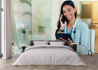 Happy manager talking on a phone in modern office, booking appointment or arranging a meeting on tablet. Young, carefree professional female talking to a client while responding to emails Wall mural