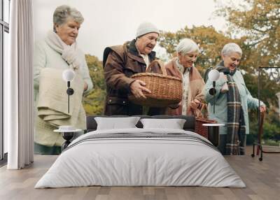 Walking, picnic and senior friends in the park together for bonding or conversation during retirement. Smile, basket and a group of happy elderly people in a garden for freedom, fresh air to relax Wall mural