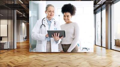 Woman doctor, medical results and tablet at hospital with patient discussion and surgery info. Wellness advice, technology and mature female professional with healthcare, consulting and talking Wall mural