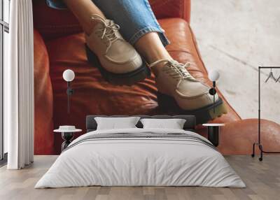 Luxurious photo of casual sneakers on teen girl sitting on old and retro armchair, studio shot photo Wall mural