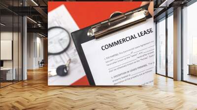 Man holds commercial lease agreement in hand. Clipboard with official document. Background with real property papers and house keys Wall mural