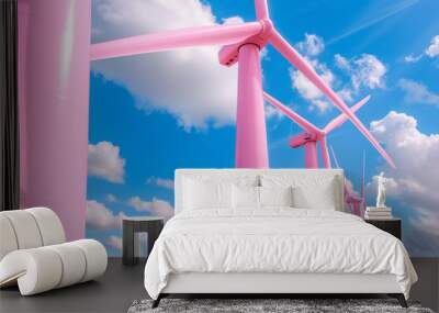 Row of vibrant pink wind turbines under a bright blue sky with fluffy white clouds. Innovative and colorful take on renewable energy. Wall mural