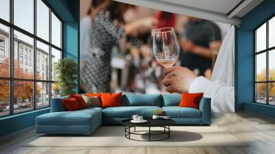 We celebrate success with a glass of rose wine in hand at a special tasting with happy people. Wall mural