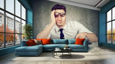 bored man employee sitting at desk has no motivation to work Wall mural