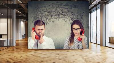 confused couple woman and man talking on the phone exchanging with many negative thoughts Wall mural