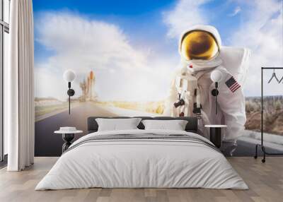 Astronaut standing on a road Wall mural