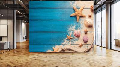 beach scene concept with sea shells and starfish on a blue wooden background Wall mural