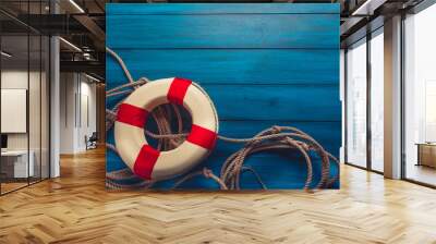 life saver with rope on a blue wooden background Wall mural