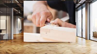 Close up of a furniture maker chiselling a chair joint Wall mural