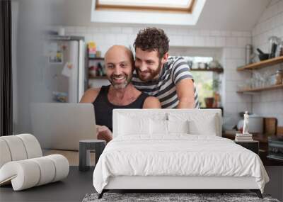 Gay couple using laptop in the kitchen Wall mural