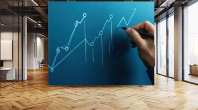 Hand Drawing an Upward Trend on a Blueboard Wall mural