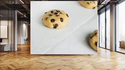 Raw chocolate chip cookie in the middle of the tray ready to bake - traditional American dessert Wall mural