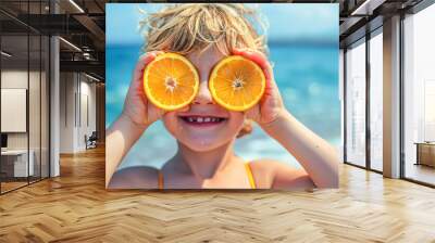 Joyful kid playing with fruit slices on sandy shore, summertime joy captured in a snapshot. Wall mural