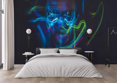 Motion, effect lightpainting man with sunglasses and colored lig Wall mural