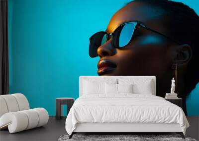 Stylish Woman Wearing Sunglasses and Earrings Against a Blue Background, Stylish Woman Wearing Sunglasses and Earrings Against a Blue Bac Wall mural