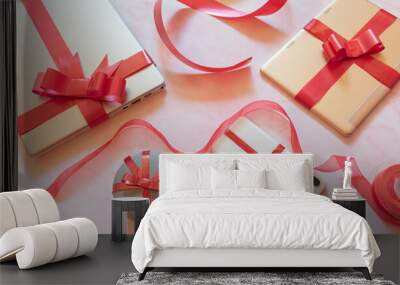 tech gifts wrapped with red gift bows Wall mural