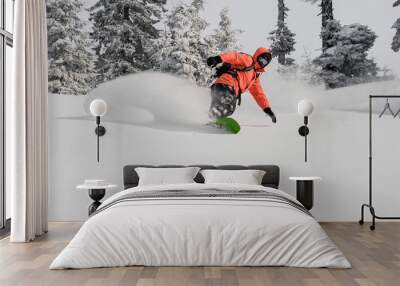 Man running down the mountain hill on the snowboard Wall mural