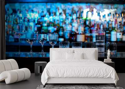 Several glasses of different forms stand on bar counter. Wall mural