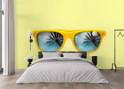 Summer concept image: yellow sunglasses with palm tree reflections isolated in pastel yellow background. Minimalist image ready for summer, sun protection, hot days and tropical travel vacation. Wall mural