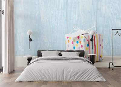 Polka dot gift box on wooden table Wall mural