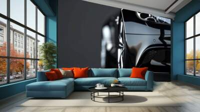 A close-up of a sleek, luxury black car's front side, highlighting the design and details under dramatic lighting Wall mural