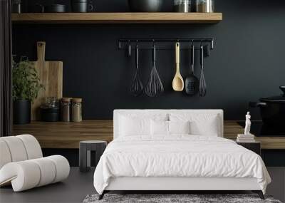 Kitchen interior with black walls, wooden countertops and wooden shelves with cooking utensils Wall mural