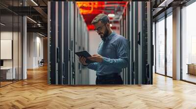 Portrait of a handsome young man with a shirt  using a tablet in a server room datacenter Wall mural