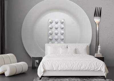 Pills on a white plate. Supplements and vitamins on the table Wall mural