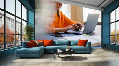 Close up of female hands typing text on laptop, Business woman using laptop while communicating with a business partner in co-working place Wall mural