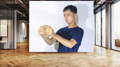 Asian teenage boy in navy blue t-shirt playing with wooden blocks Wall mural