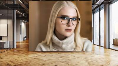 Young stylish woman wearing glasses. Blond business woman looking at the camera Wall mural