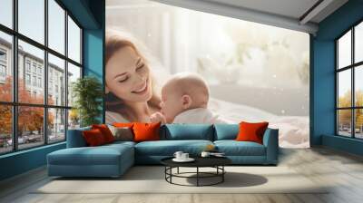 Beautiful young mom and her cute baby  in bed Wall mural