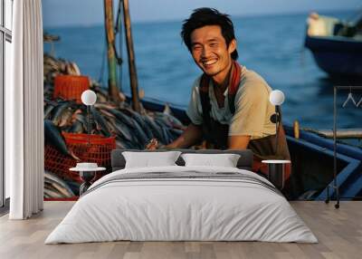 Happy asian fisherman with a lot of fishes on a fishing boat Wall mural