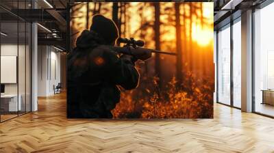 Hunter in holding rifle and shooting at evening forest. Wall mural