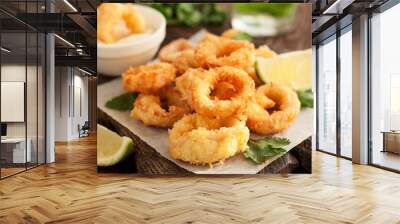 Fried calamari rings on wooden cutting board Wall mural