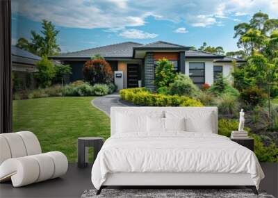 Modern suburban house with wellmaintained front yard and garden on sunny day Wall mural