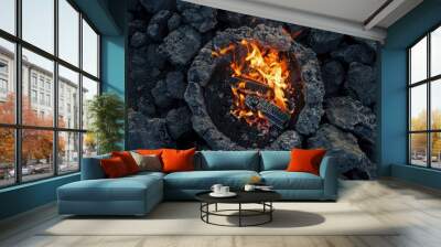 Top view of a campfire against rocky ground  intense heat & bright flames Wall mural