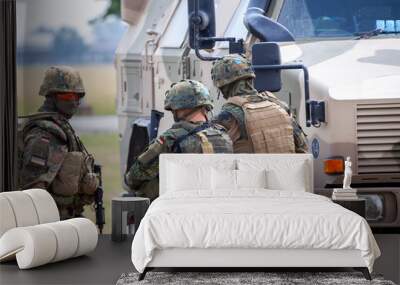 German soldiers stands near military vehicles on a open day on day of the Bundeswehr in Feldkirchen Wall mural